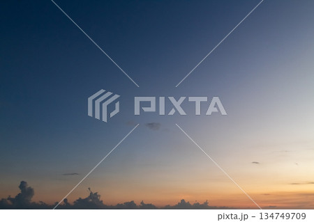 Dramatic sunset sky with gradient colors and cloud silhouettes for atmospheric background with natural light and copy space Dramatic sunset sky with gradient colors and cloud silhouettes for atmospheric background with natural light and copy space 134749709