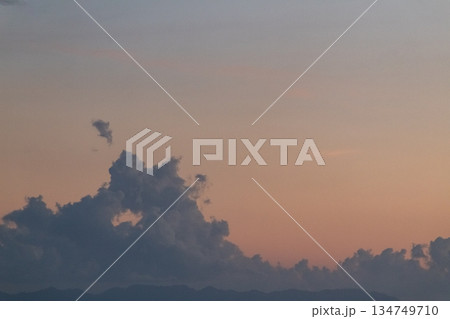 Dramatic cloudscape with vibrant orange and pink sky at dusk, creating a serene and picturesque scene for atmospheric backgrounds Dramatic cloudscape with vibrant orange and pink sky at dusk, creating a serene and picturesque scene for atmospheric backgrounds 134749710