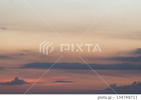 Dramatic sunset sky with colorful clouds and soft light casting a serene atmosphere, ideal for travel and inspirational concepts Dramatic sunset sky with colorful clouds and soft light casting a serene atmosphere, ideal for travel and inspirational concepts 134749711