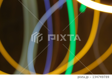 Abstract Light Trails with Slow Shutter Speed creating blurry colorful curves on dark background, perfect for artistic and dreamy visuals Abstract Light Trails with Slow Shutter Speed creating blurry colorful curves on dark background, perfect for artistic and dreamy visuals 134749789