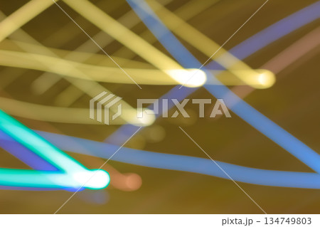 Abstract light trails creating dynamic blurred patterns with slow shutter speed effect, showcasing vibrant colors against a dark background for artistic expression Abstract light trails creating dynamic blurred patterns with slow shutter speed effect, showcasing vibrant colors against a dark background for artistic expression 134749803