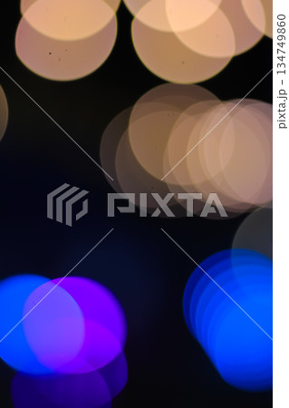 Abstract blurred bokeh lights background with blue and gold tones creating a dreamy atmosphere, perfect for festive season designs 134749860