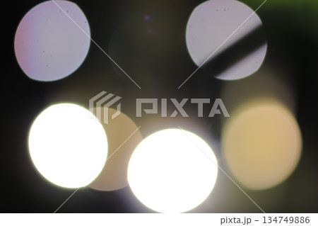 Abstract Bokeh Lights Forming Soft Glowing Circles on Dark Background for Festive or Dreamy Ambiance 134749886