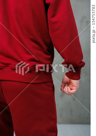 Captivating Stylish Red Sportswear A CloseUp of a Man Wearing an Athletic Tracksuit, Radiating Energy and Focused Pose, Perfectly Illustrating the Spirit of Modern Athletic Fashion 134753783