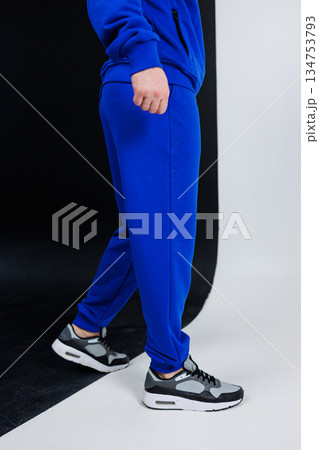 Experience the ultimate in fashionable casual sportswear with our blue tracksuit, perfectly paired with stylish sneakers, designed for those who lead an active lifestyle and love to stay fit 134753793