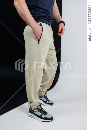 Trendy Casual Wear These stylish beige joggers, when paired with trendy athletic sneakers, create an effortlessly modern street look that is perfect for a variety of casual occasions Trendy Casual Wear These stylish beige joggers, when paired with trendy athletic sneakers, create an effortlessly modern street look that is perfect for a variety of casual occasions 134753804
