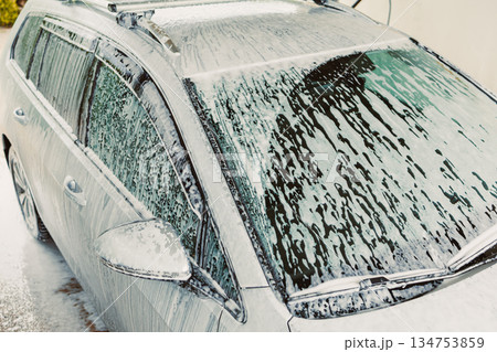 The Car Wash Process Involves Carefully Applying Soap Foam to the Vehicle During a Thorough and Comprehensive Cleaning Session to Ensure a Sparkling Clean and Absolutely Spotless Finish for the Car The Car Wash Process Involves Carefully Applying Soap Foam to the Vehicle During a Thorough and Comprehensive Cleaning Session to Ensure a Sparkling Clean and Absolutely Spotless Finish for the Car 134753859