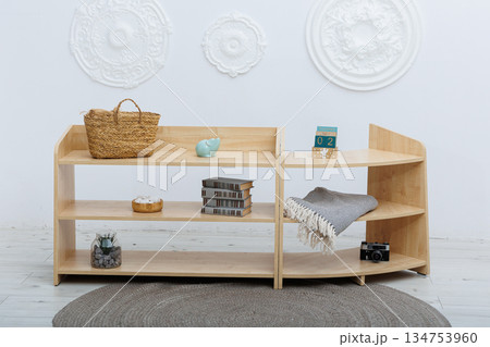 A Modern Wooden Shelf Featuring Beautiful Decorative Items in a Stylish Studio Space 134753960