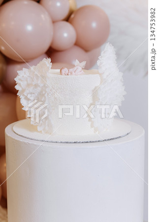 An Elegant White Cake adorned with beautiful Decorative Flowers and a smooth Buttercream Finish, perfect for any special occasion or celebration that calls for a delicious confectionery treat An Elegant White Cake adorned with beautiful Decorative Flowers and a smooth Buttercream Finish, perfect for any special occasion or celebration that calls for a delicious confectionery treat 134753982
