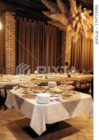 An elegant dining setup featuring a variety of assorted dishes alongside stylish decor creates a captivating atmosphere in a modern restaurant setting, perfect for any culinary gathering 134753986