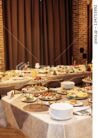 An Elegant Buffet Setup Featuring an Impressive Variety of Delicious Dishes and Refreshments, Perfect for a Celebratory Event or a Special Occasion that Brings People Together in Style and Comfort 134753992