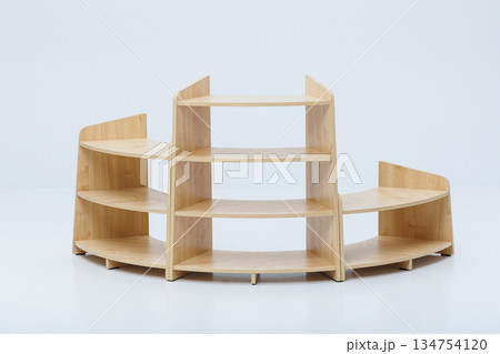 A wooden shelf is currently resting on a clean white surface 134754120