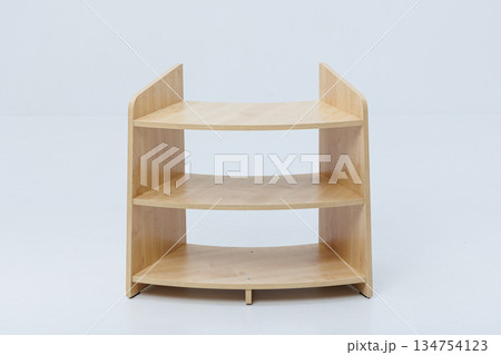A wooden shelf with three distinct levels on a white background 134754123