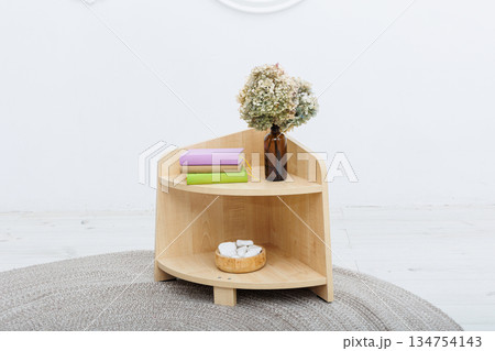 A beautifully crafted wooden table adorned with a vase of flowers on it 134754143