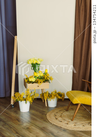 A bright and cheerful yellow floral arrangement beautifully enhances a modern interior setting, creating an inviting and vibrant atmosphere ideal for home decor and personal renewal and rejuvenation 134754211