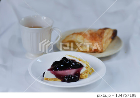 blueberry cheese cake, blueberry cheese tart or cheesecake with pie and hot tea blueberry cheese cake, blueberry cheese tart or cheesecake with pie and hot tea 134757199