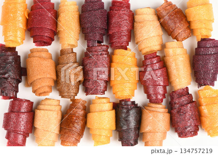 Large Background Pattern of Assorted Fruit Leather Rolls 134757219