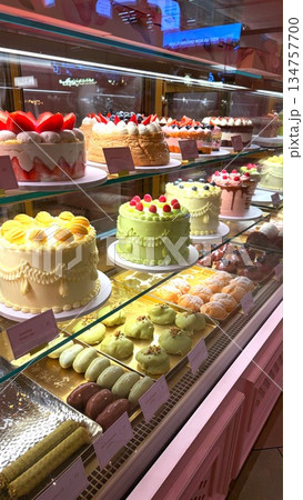 Colorful Array Of Sweets, Decorative Case Filled With Delightful Baked Treats, Vibrant Bakery Presentation Featuring Assortment Of Appealing And Sweet Baked Confections Displayed Attractively 134757700