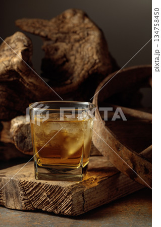 Whiskey with ice on a old wooden board. Whiskey with ice on a old wooden board. 134758450