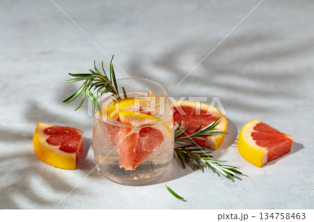 A refreshing summer drink with ice, grapefruit and rosemary. A refreshing summer drink with ice, grapefruit and rosemary. 134758463