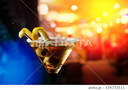 Glass of Martini with green olives and lemon peel. Glass of Martini with green olives and lemon peel. 134758511