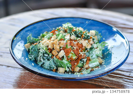 caesar salad or vegetable salad with bacon 134758978