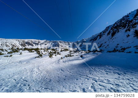 Ski lift infrastructure with scenic mountain view in winter. 134759028