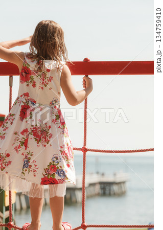 Little toddler girl playing outside on playground 134759410