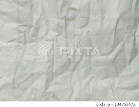 Abstract texture of crumpled paper. The paper exhibits numerous folds, wrinkles, and shadows Abstract texture of crumpled paper. The paper exhibits numerous folds, wrinkles, and shadows 134759472