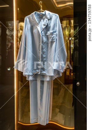 Blue Striped Pajama Set Hanging in Storefront Display for Sale, Casual Sleepwear Look, Home Lifestyle Blue Striped Pajama Set Hanging in Storefront Display for Sale, Casual Sleepwear Look, Home Lifestyle 134759788