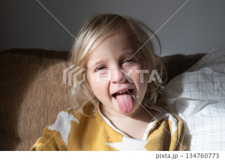Girl Relaxing on Sofa and Fooling Around at Home on Weekend Girl Relaxing on Sofa and Fooling Around at Home on Weekend 134760773