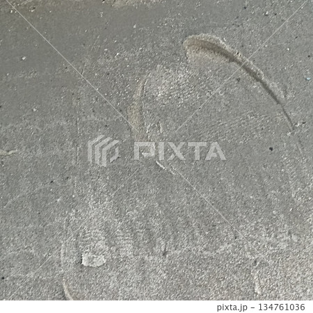 Close-up of subtle footprints in a layer of dust. This image provides a textured background, perfect for adding depth to designs, overlays, or creative projects. Evokes mystery and storytelling. Close-up of subtle footprints in a layer of dust. This image provides a textured background, perfect for adding depth to designs, overlays, or creative projects. Evokes mystery and storytelling. 134761036