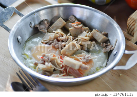 Pan fried eggs with toppings , Skillet Egg or fried egg with sausage and minced pork topping 134761115