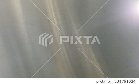 A smooth, silver texture provides a sophisticated and clean backdrop. Ideal for graphic design, website backgrounds, presentations, and various creative projects. Its neutral tone ensures versatility. 134761924