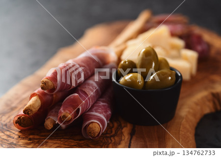 Italian snacks on olive wood board 134762733