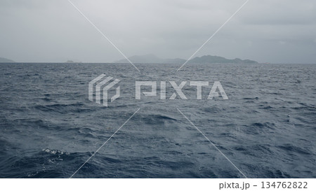 Sailing on a boat around Seychelles island on a foggy day 134762822