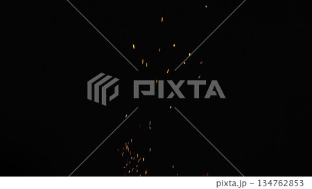 sparks and embers from campfire flying over black background sparks and embers from campfire flying over black background 134762853