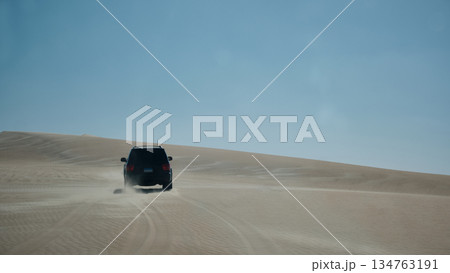 Off-Road Vehicle Driving Across Desert Dunes 134763191