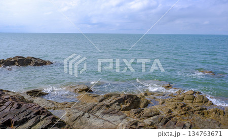 Serene Coastal Landscape with Rocks and Open Sea 134763671
