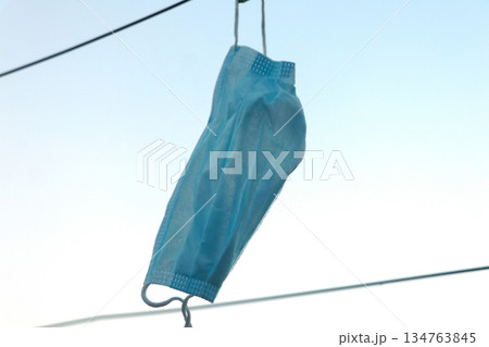 Disposable Face Mask Hanging on a Clothesline Disposable Face Mask Hanging on a Clothesline 134763845
