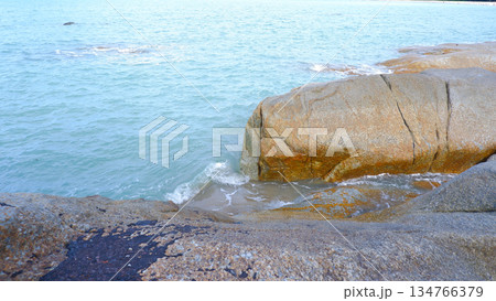 Close Up of Granite Rocks and Sea Waves Close Up of Granite Rocks and Sea Waves 134766379