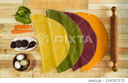 Colored dough for noodles stretched on the table, 134767172