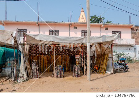 India, Pushkar, Scene of daily life during the annual fair. Sale of colorful wooden sticks. 134767760