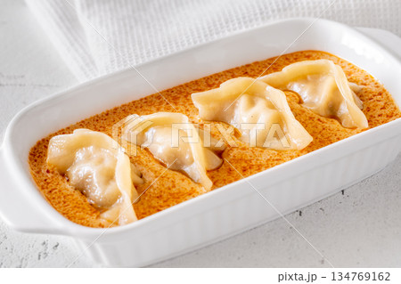 Gyoza dumplings served in creamy Tom Yum sauce with elegant minimalist presentation Gyoza dumplings served in creamy Tom Yum sauce with elegant minimalist presentation 134769162