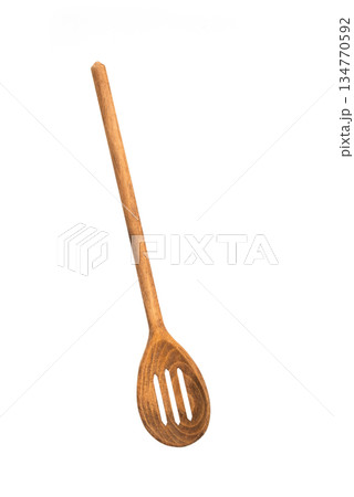 Wooden slotted spoon isolated on white background, natural kitchen utensil for cooking, serving, and food preparation. Wooden slotted spoon isolated on white background, natural kitchen utensil for cooking, serving, and food preparation. 134770592