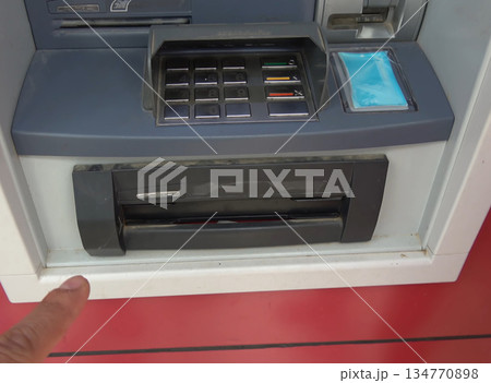 ATM for receiving funds. Hands of a man at an ATM. 134770898