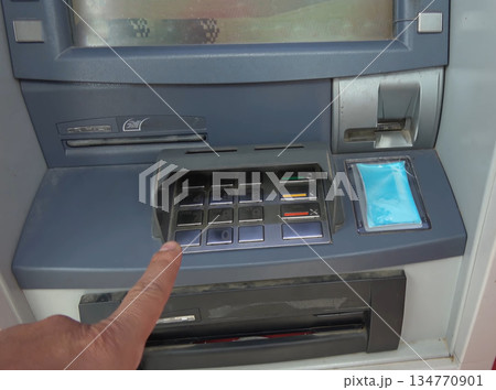ATM for receiving funds. Hands of a man at an ATM. ATM for receiving funds. Hands of a man at an ATM. 134770901