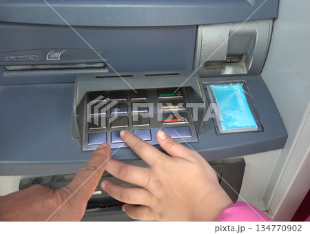 ATM for receiving funds. Hands of a man at an ATM. ATM for receiving funds. Hands of a man at an ATM. 134770902