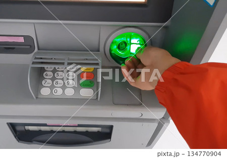 ATM for receiving funds. Hands of a man at an ATM. 134770904