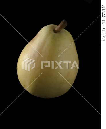 One ripe, juicy pear, on a black background One ripe, juicy pear, on a black background 134771155
